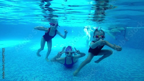 Underwater video of young friends in swimming pool
