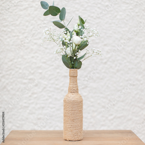 Vase bouteille, rose et branches d'eucalyptus Fototapet