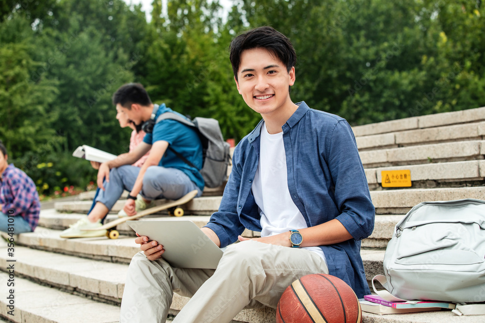 Happy college students sat on the steps of learning