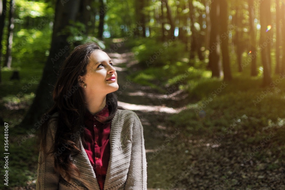 Happy girl looking in the sky. Woman enjoys time in forest alone on quarantine. Happy girl looking in the sky. Woman enjoys time in forest alone on quarantine.