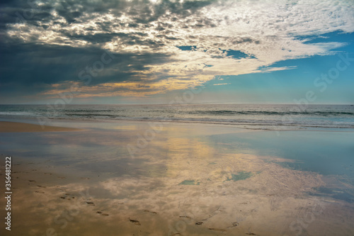 Fototapeta Naklejka Na Ścianę i Meble -  Cloudy afternoon walking alone on the beach