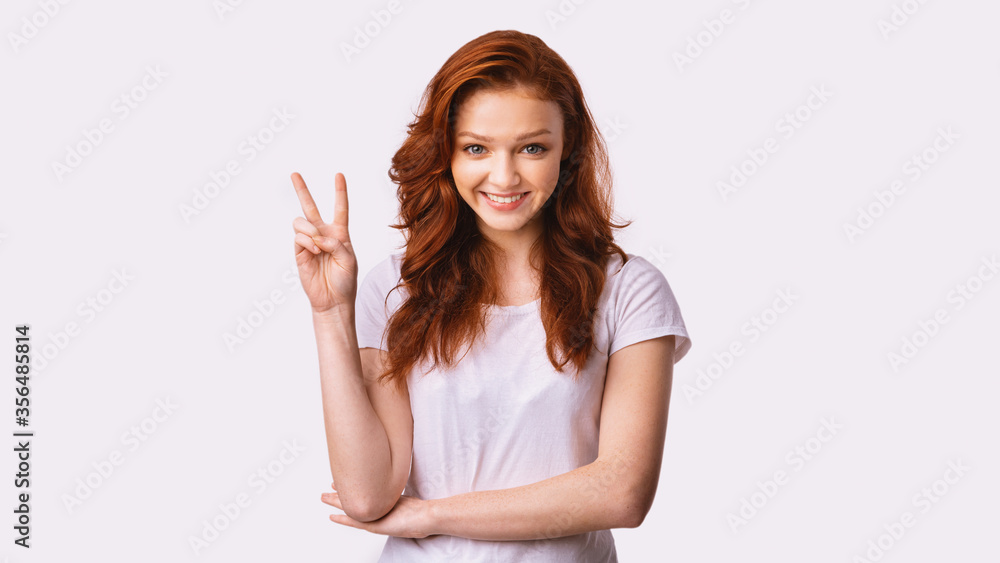 Smiling Student Girl Gesturing Victory Sign Posing In Studio, Panorama Smiling Student Girl Gesturing Victory Sign Posing In Studio, Panorama