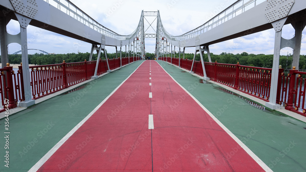 Park pedestrian bridge over the Dnieper River, which connects the central part of Kiev with the park area and the beaches of Trukhanovy Island. Without people.