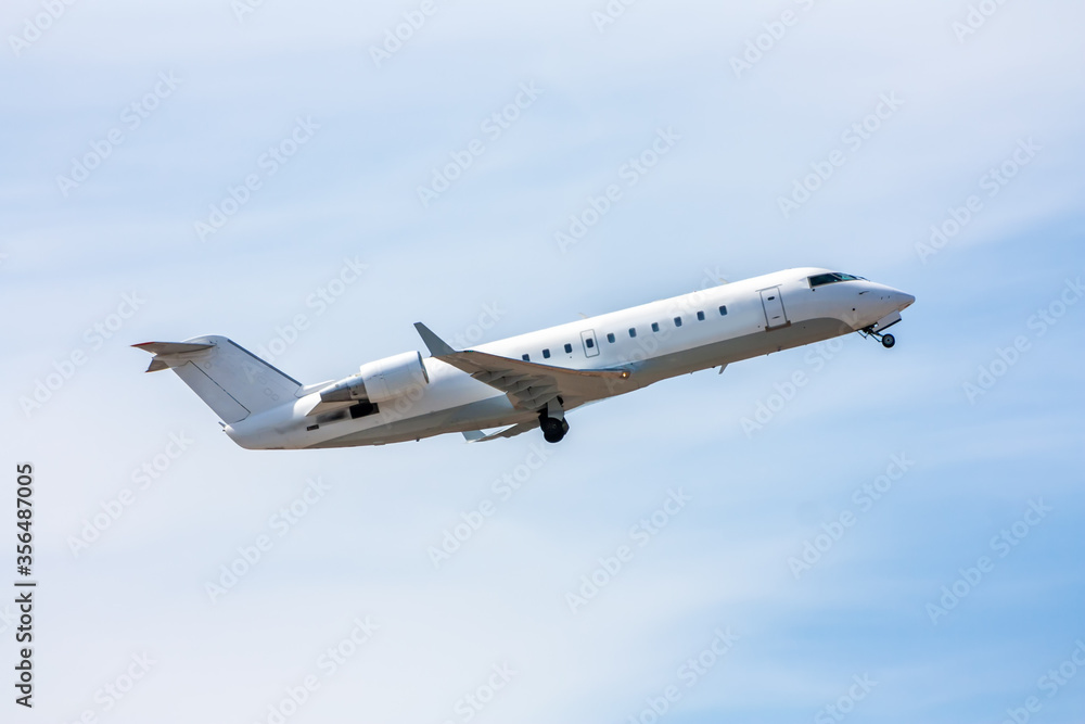Take-off a white regional jet against a blue sky Take-off a white regional jet against a blue sky