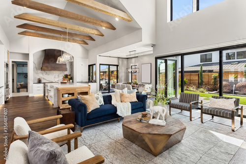 Living room and kitchen interior in new luxury home with large windows photo