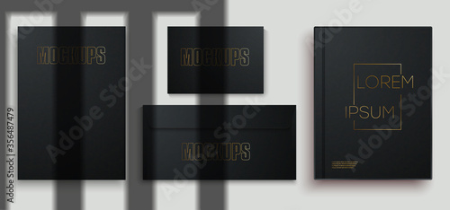 Black stationery business branding mock up template, on gray background to place your design. Blank book, envelope, business card, A4 sheet paper, cover layout design with shadows for branding. Vector