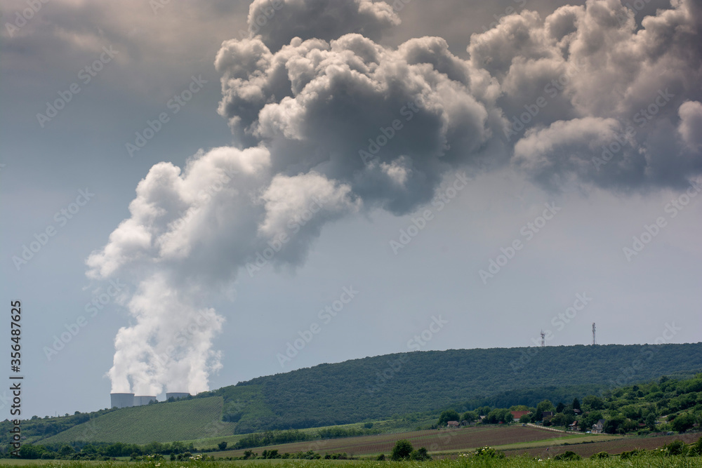 Clouds of steam coming out from cooling towers of nuclear power plant. Clouds of steam coming out from cooling towers of nuclear power plant.