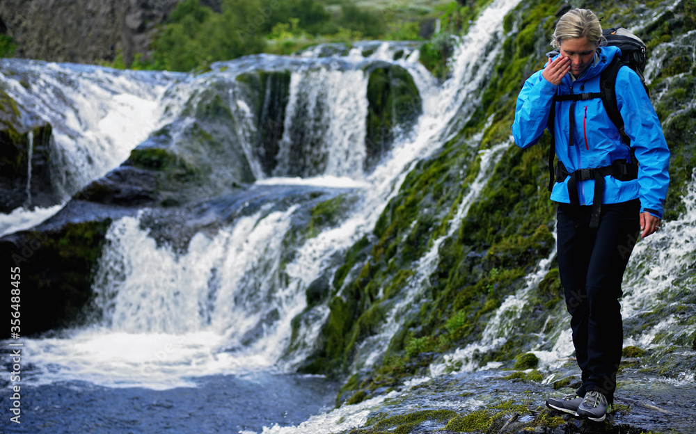 woman exploring waterfalls at Gj·in in the fijÛrs·rdalur valley woman exploring waterfalls at Gj·in in the fijÛrs·rdalur valley