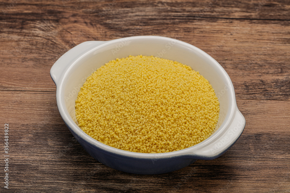 Raw cous cous heap in the bowl Raw cous cous heap in the bowl