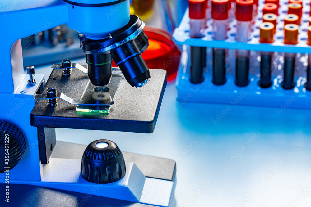 Microscope with blood samples test tubes close up Microscope with blood samples test tubes close up