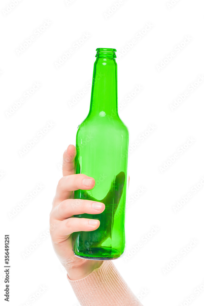 green empty beer bottle in female hand on a white background green empty beer bottle in female hand on a white background