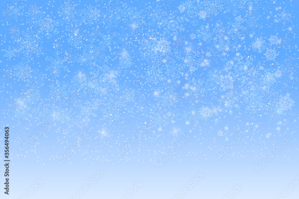 Defocused white snowflakes on a blue background