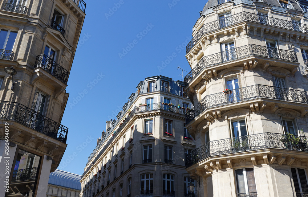 Traditional French houses with typical balconies and windows. Paris.