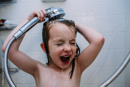 Close up of girl washing her hair with shower