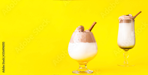 Creative layout with Dalgona Coffee on yellow background. Trendy cold Korean and Indian drink. Sustainable Wellness. Close-up