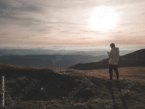man standing on top of the mountain
