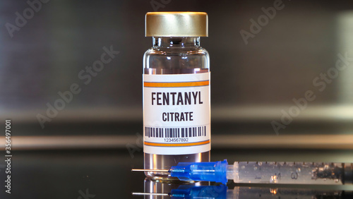 Fentanyl drug and syringe on black table