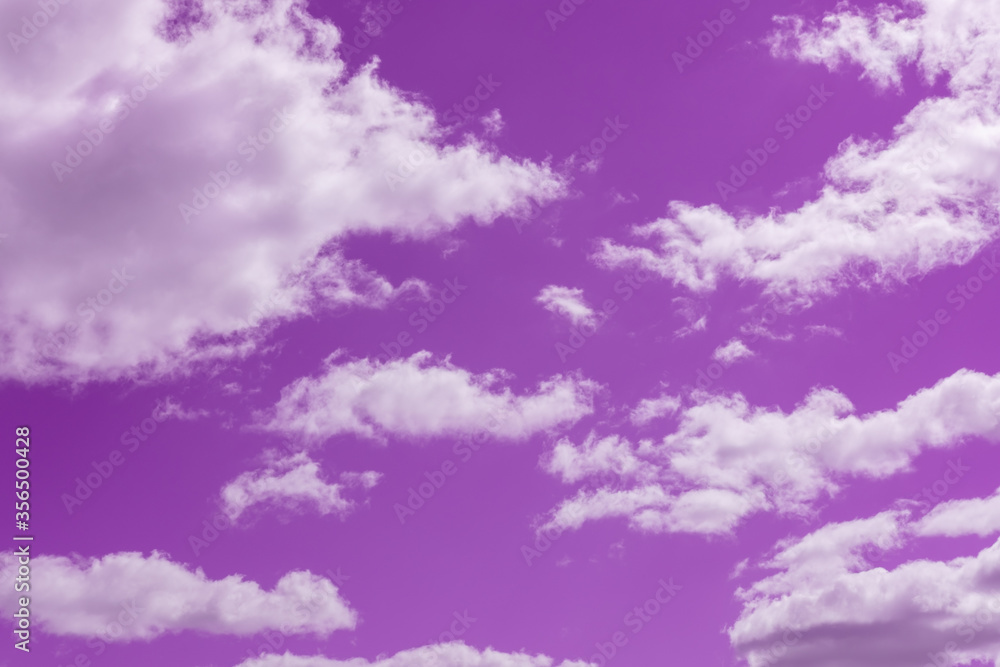 Bright beautiful pink sky with white clouds. Great for design and texture background.
