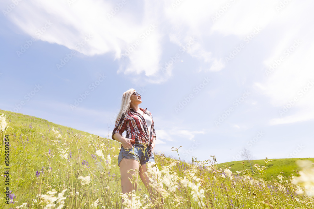 Lifestyle summer image of pretty blonde hipster woman with bag pack traveling and enjoying, stylish fresh look, happy mood, sunny colors, travel concept, emotions.