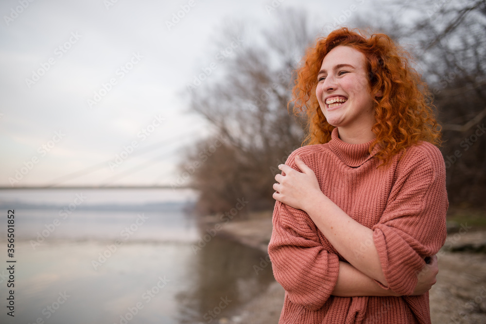 young hipster in an elegant sweater, smiling face, posing during an autumn day young hipster in an elegant sweater, smiling face, posing during an autumn day