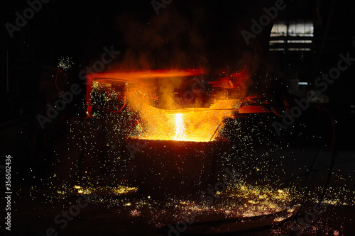Steelmaker at ingot casting. Electric arc furnace shop EAF. Metallurgy.