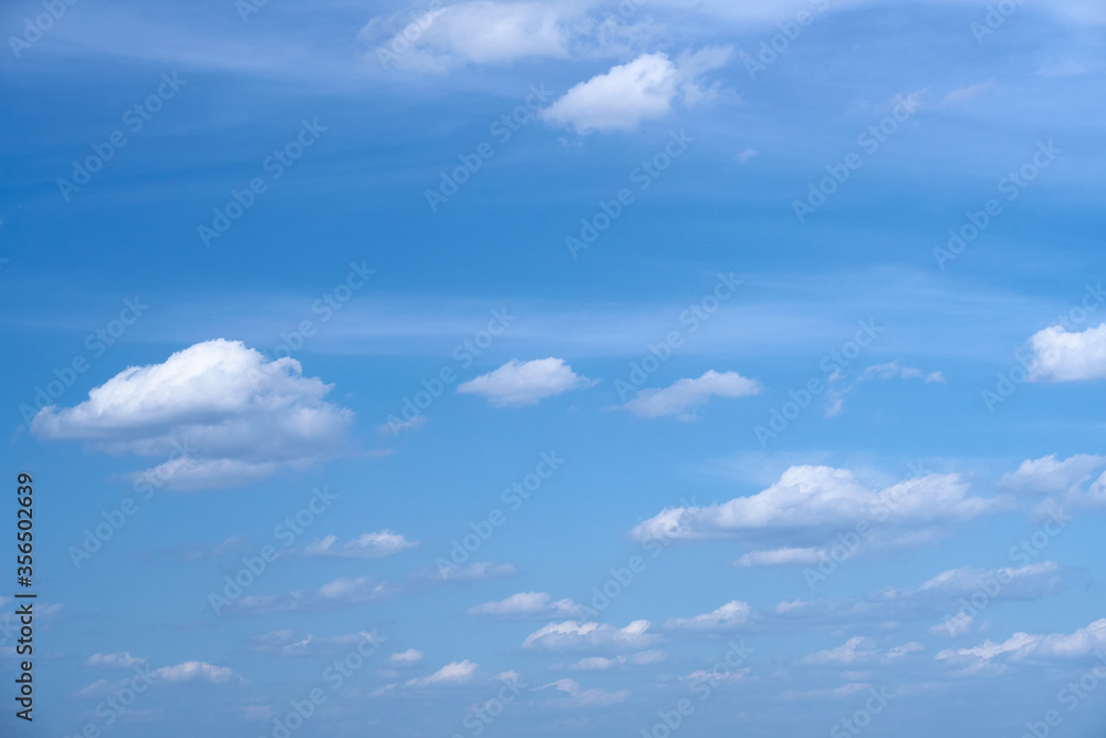 Bright beautiful blue sky with soft clouds, bright sunny day Bright beautiful blue sky with soft clouds, bright sunny day