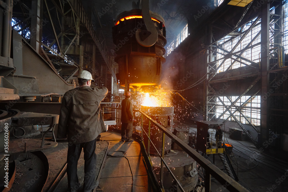 Steelmaker at ingot casting. Electric arc furnace shop EAF. Metallurgy.