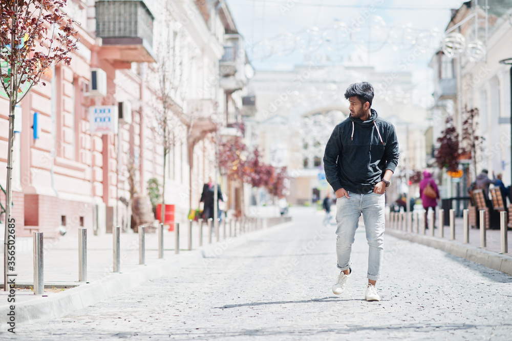 Portrait of young stylish indian man model pose in street. Portrait of young stylish indian man model pose in street.