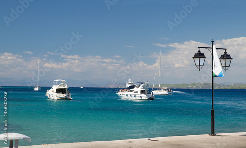 Tranquil scene with white yachts from coastline of Greek island Spetses