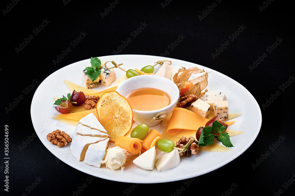 tasty cheese plate with honey on a big white plate tasty cheese plate with honey on a big white plate