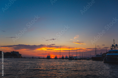 Boats during colorful sunset at the harbour in Zadar, Croatia © Joppi