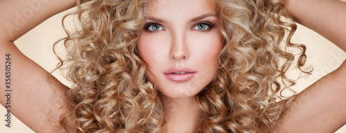 Beautiful blonde woman. Healthy Long Blond Hair. Curly Hair. Blond. Permed Hair. Afro curls. Long blond Hair.  Beauty Model Girl with Luxurious Hair.
