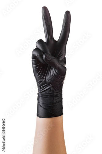 Hand in black gloves showing two fingers up in peace or victory symbol on white