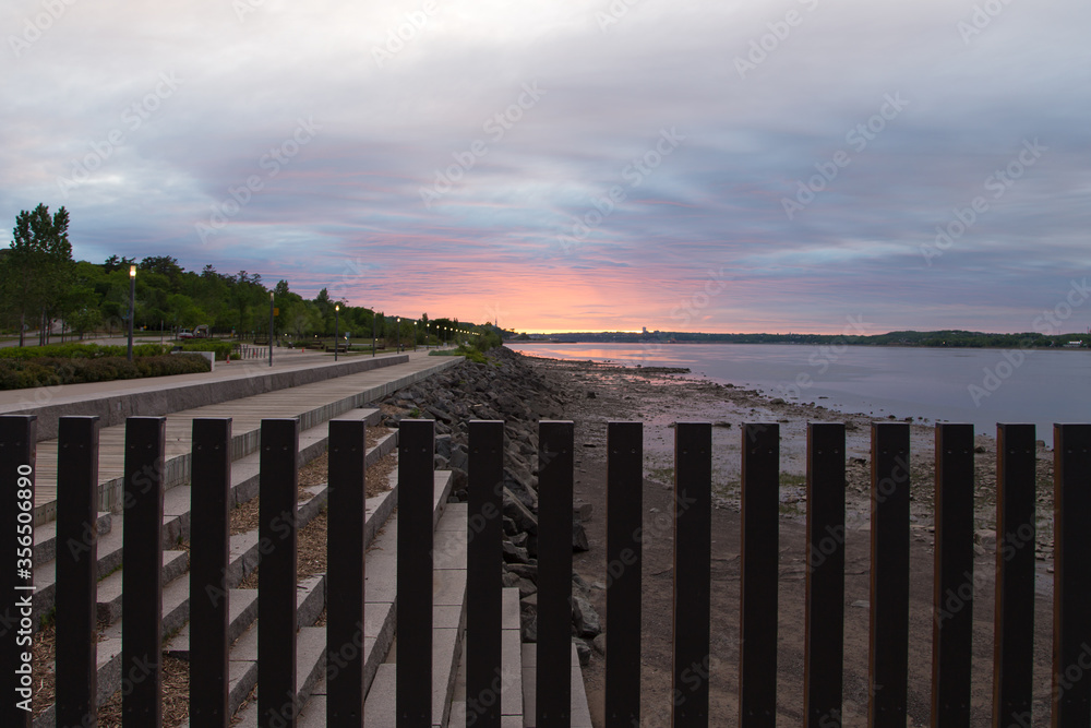 East view of the St. Lawrence River at low tide and Samuel-de-Champlain Walk seen during a beautiful cloudy dawn from the Quai des Cageux, Quebec City, Quebec, Canada