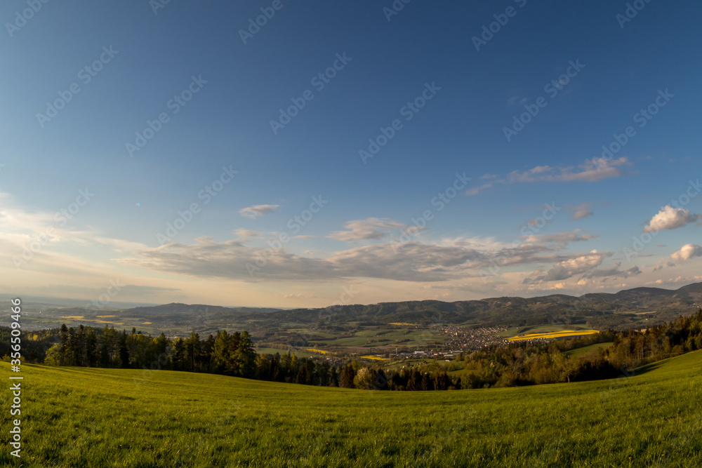 Landscape with lots of clouds in the mountainous area of the Beskydy Mountains during a sunny afternoon.