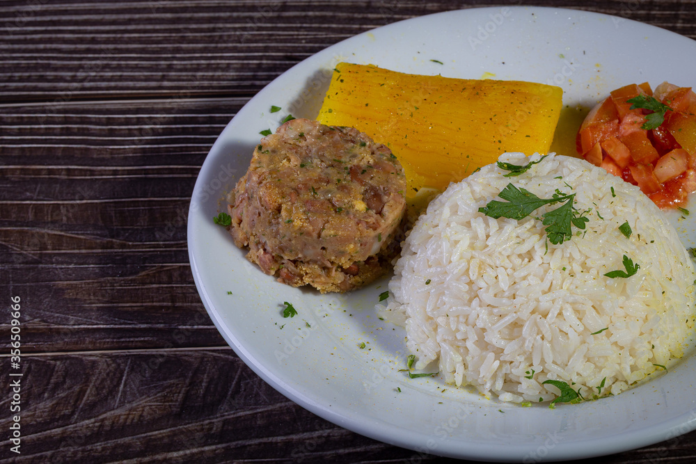Rice and beans, traditional brazilian dish with manioc and salad. Rice and beans, traditional brazilian dish with manioc and salad.