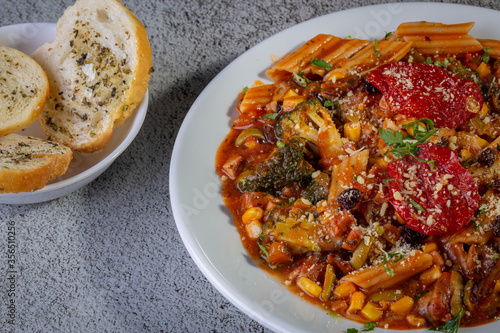 Penne pasta with tomato sauce and vegetables