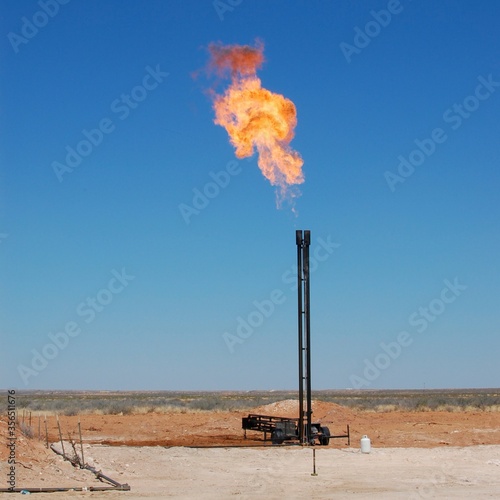 Small gas flare at a well in the west Texas oilfield