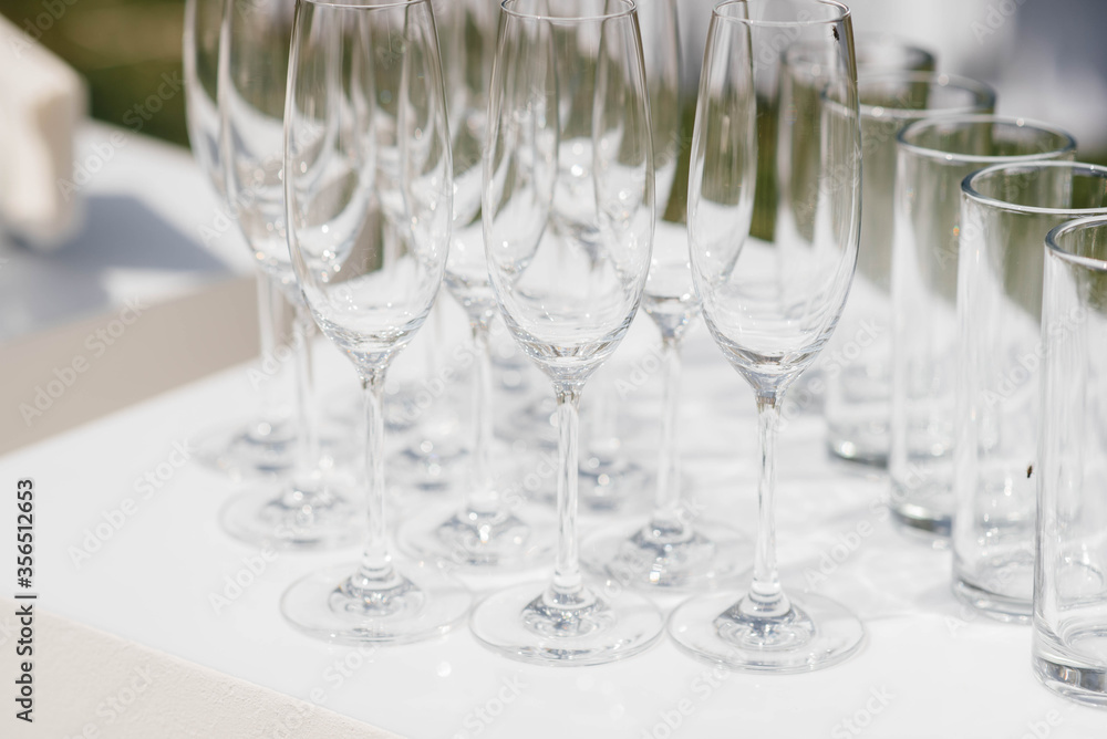 Festive glasses on the festive table during the Banquet. Alcoholic beverage Festive glasses on the festive table during the Banquet. Alcoholic beverage