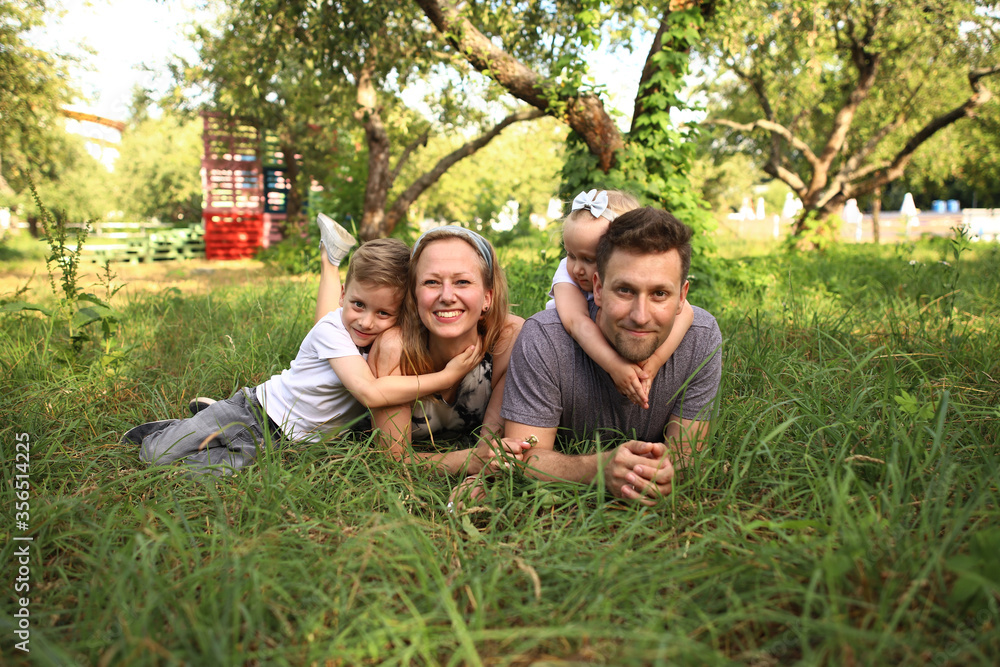 Happy loving family with two children, son and daughter playing and hugging. Family walk. Happy Mothers day. Happy loving family with two children, son and daughter playing and hugging. Family walk. Happy Mothers day.