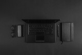 Minimal flat lay on modern businessman black desk with laptop