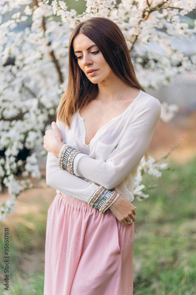 Amazing young woman posing in Blooming tree orchard at spring Amazing young woman posing in Blooming tree orchard at spring