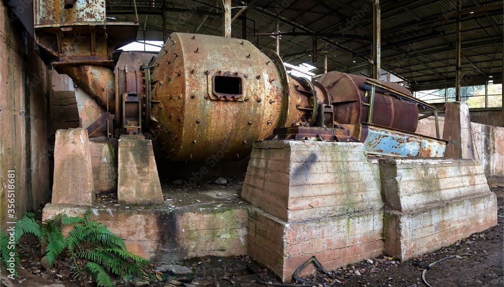 Rusty metal mechanism with pipes inside of abandoned industrial workshop in Spain Rusty metal mechanism with pipes inside of abandoned industrial workshop in Spain