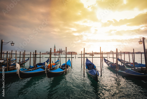 Famous Venetian gondolas in canal. Gondola is hallmark of Venice  Italy.