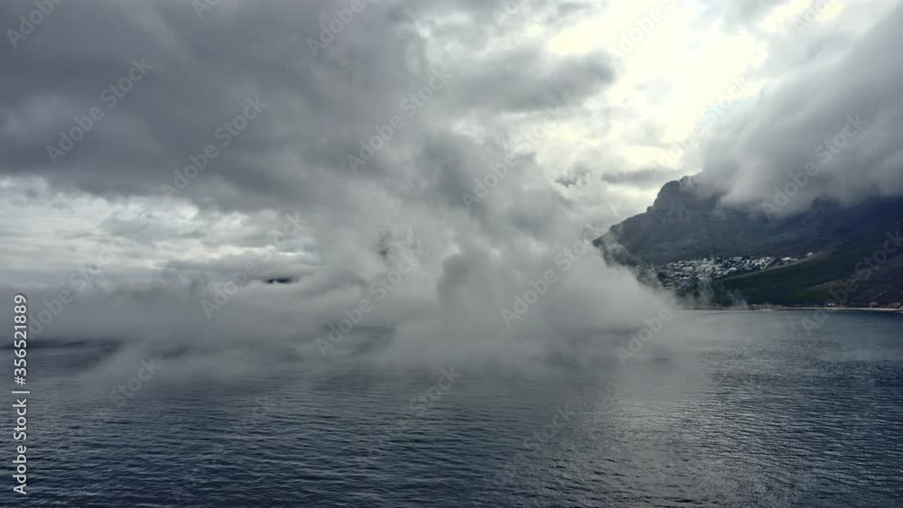 Mighty Mountains Peeping from Behind the Thick Fog by the Ocean Mighty Mountains Peeping from Behind the Thick Fog by the Ocean