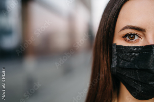young woman in a protective mask 