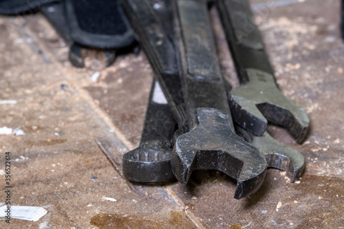 Close up of wrenches laying on workbench