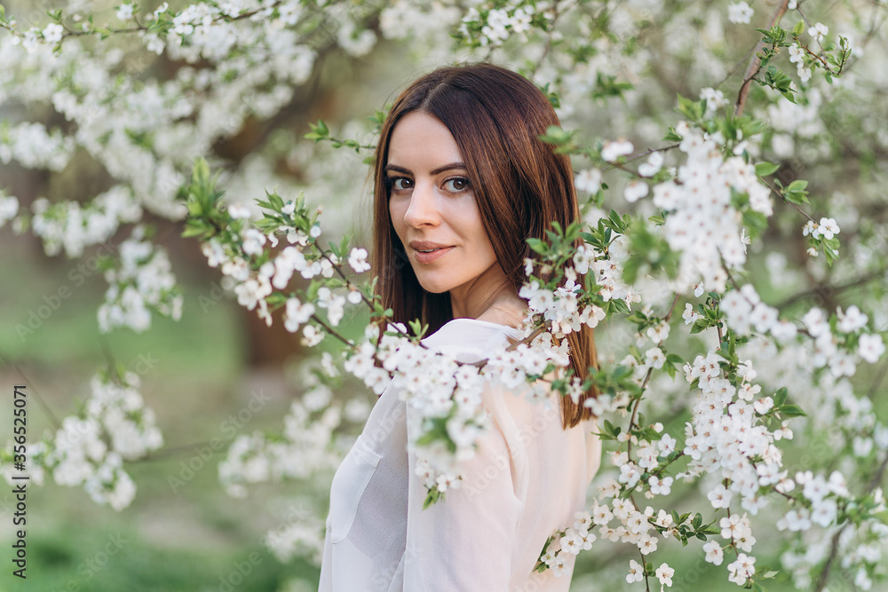 Amazing young woman posing in Blooming tree orchard at spring Amazing young woman posing in Blooming tree orchard at spring