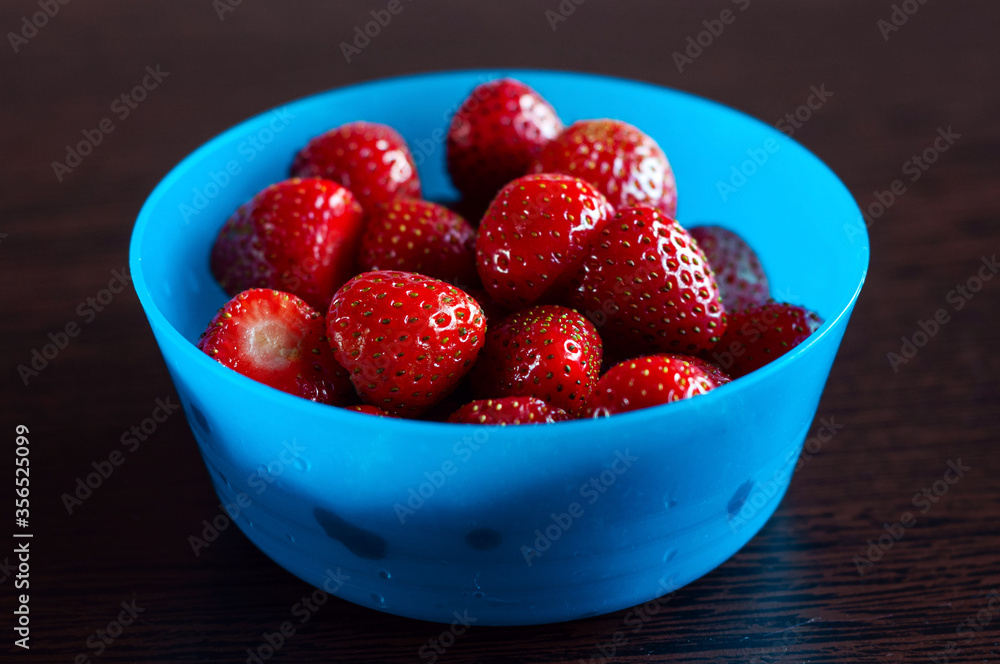Strawberries in a blue bowl, isolated, healthy snack Strawberries in a blue bowl, isolated, healthy snack