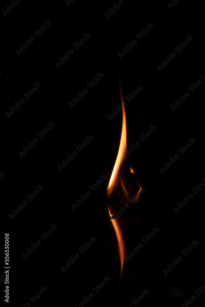 Burning Flame with reflection on black background Burning Flame with reflection on black background